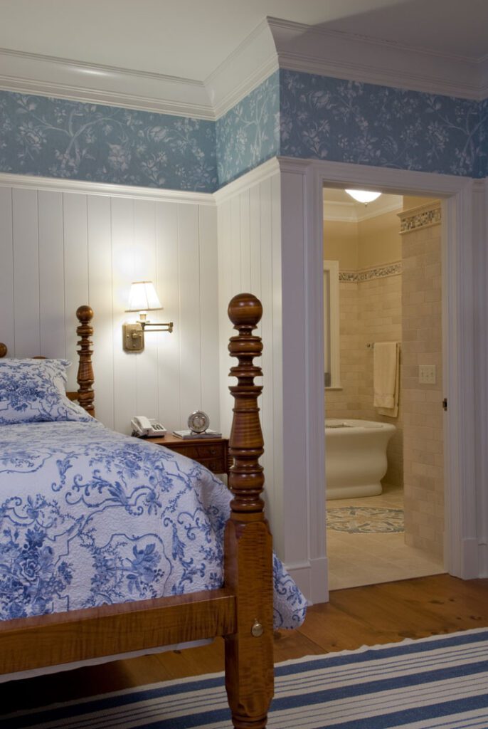 white and blue bedroom with wooden bedposts
