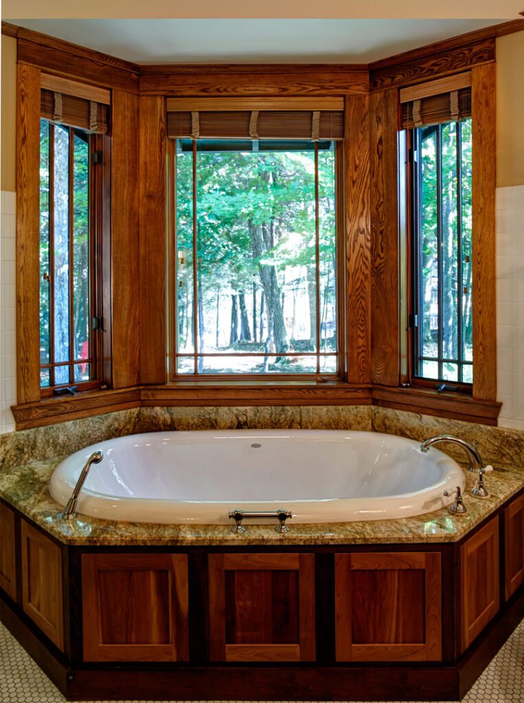 bathroom with wood and marble bathtub and angled windows