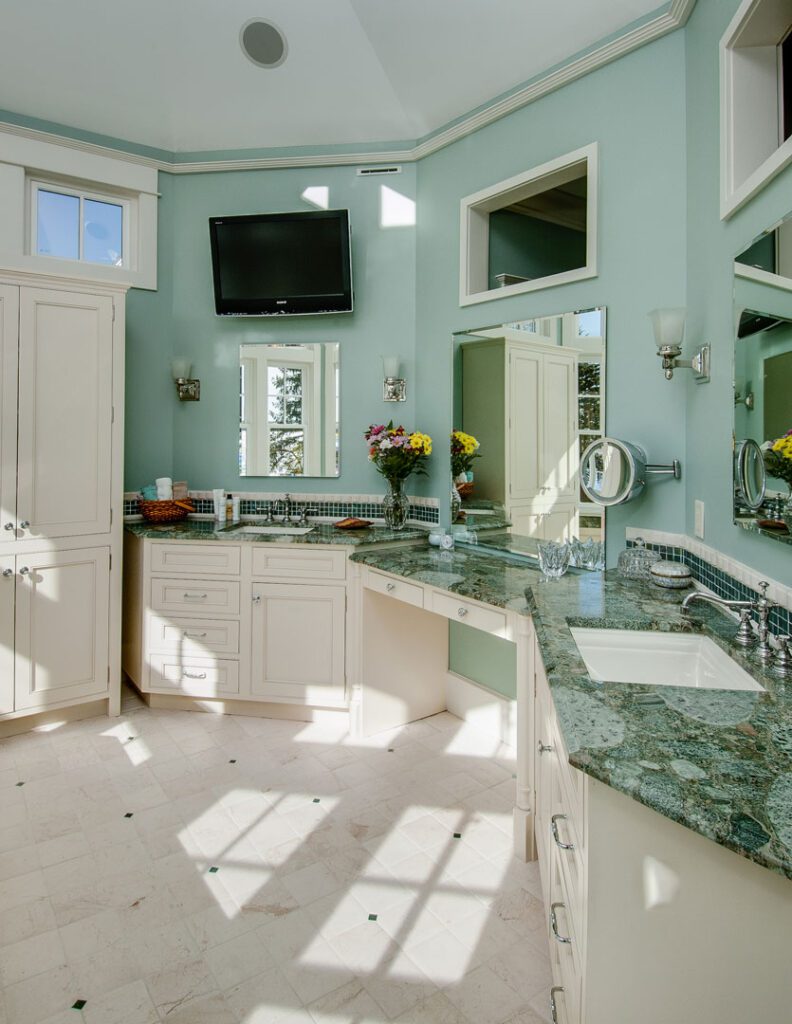 mint walls and white cabinets with marble countertop
