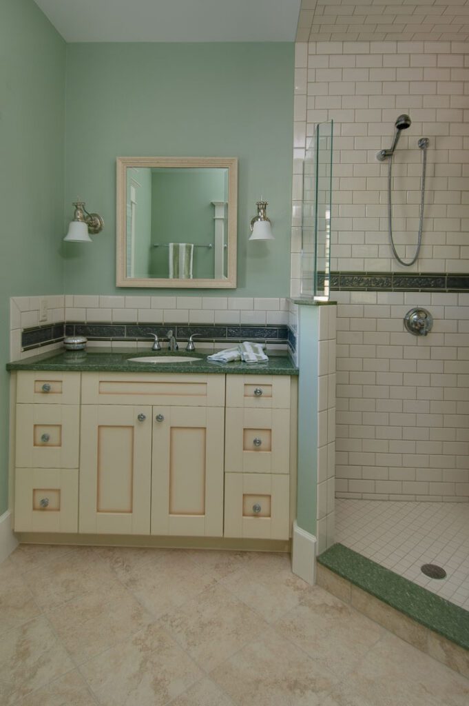 green walls and white marble floor with shower and sink